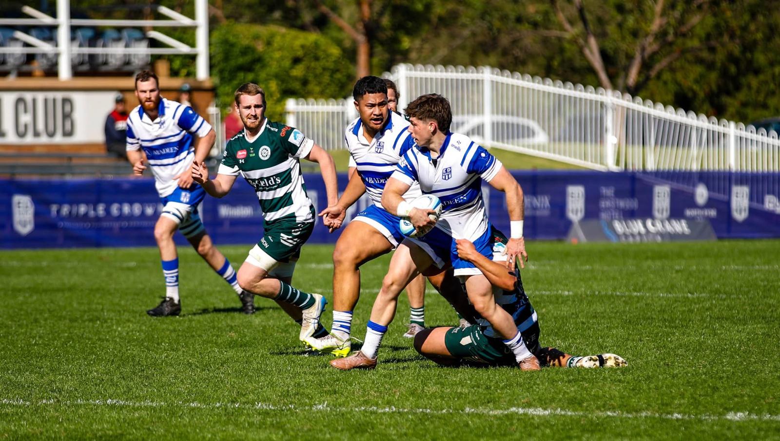 Tom Price carrying the ball through contact in a competitive match