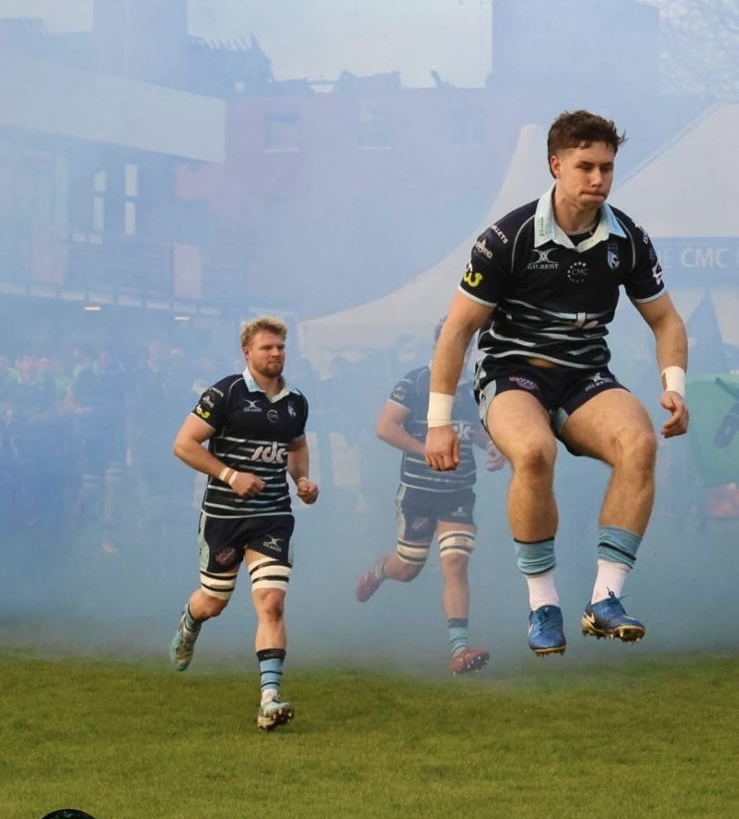 Tom Price entering the field through match-day smoke